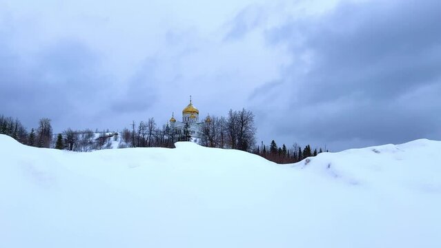 Belogorsky St. Nicholas Orthodox Missionary Monastery. Russia, Perm Krai, Belaya Gora. The temple on the hill in winter. Monastery on the background of snow.