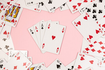 Poker playing cards on pink background