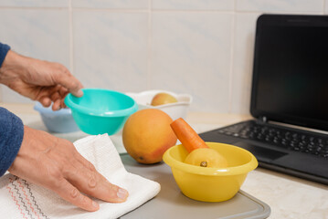 Young man preparing vegetarian healthy meal from video tutorial