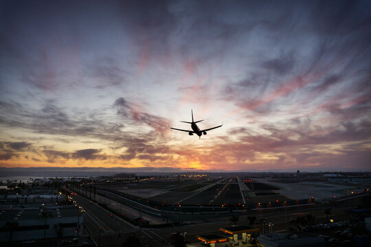 Silhouette airplane landing at airport