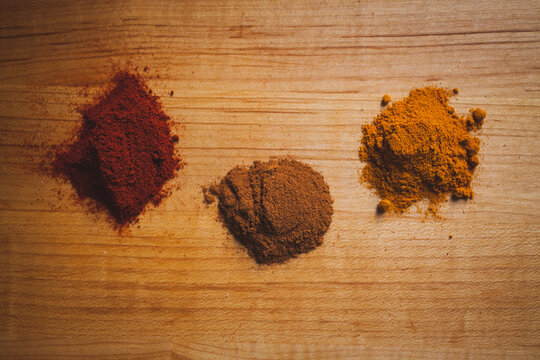 Overhead view of various spices on wooden table