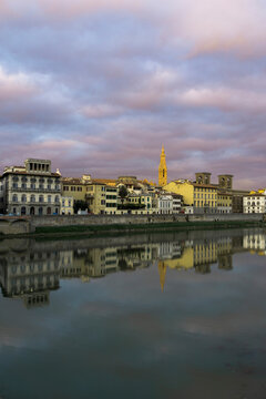 Scuola del Cuoio by Arno river against cloudy sky during sunset in city
