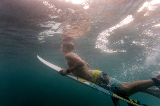 Side view of man surfing undersea