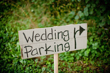 Wedding parking text on wooden plank at field