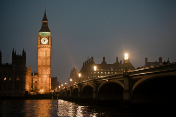 Illuminated Big Ben and Westminster Bridge against clear sky at night