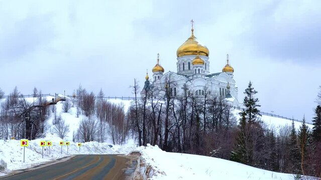 Belogorsky St. Nicholas Orthodox Missionary Monastery. Russia, Perm Krai, Belaya Gora. The temple on the hill in winter. Monastery on the background of snow.