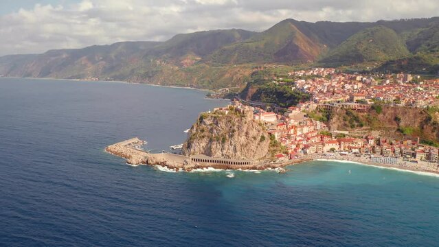4k drone flight moving to the side footage (Ultra High Definition) of Reggio Calabria, Italy, Europe. Attractive summer cityscape of Scilla port. Spectacular morning seascape of Mediterranean sea.