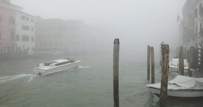 Water Taxi on Canal Grande in Venice on a foggy winter day 