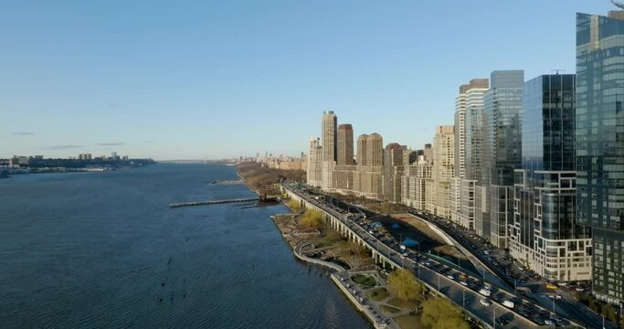 Aerial view flying parallel to the Joe DiMaggio West Side Highway, sunny spring day in Lincoln Square, NY, USA