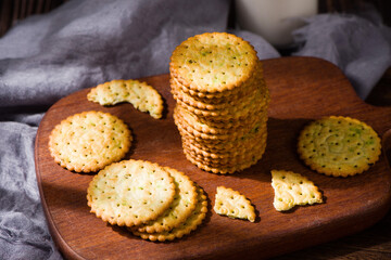 round thin crispy biscuits or crackers on wooden table