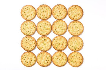 Heap of round thin crispy biscuits isolated on white background.