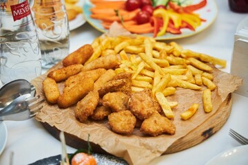 Fast food French fries and nuggets from different types of meat.