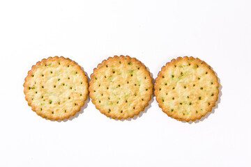 Heap of round thin crispy biscuits isolated on white background.