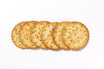 Heap of round thin crispy biscuits isolated on white background.
