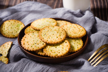 round thin crispy biscuits or crackers on wooden table