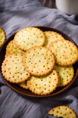 round thin crispy biscuits or crackers on wooden table