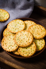 round thin crispy biscuits or crackers on wooden table