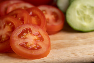 Sliced red fresh tomatoes on a board
