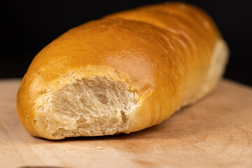 Wheat baguette on a wooden cutting board