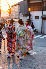 Japanese girls in kimono at sunset in Kyoto.