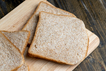 Square loaf of light wheat bread cut into pieces