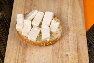 Wheat bun with large pieces of processed cheese inside