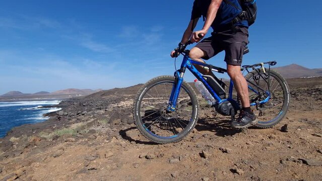 ciclyng bicycle at the coast of Lanzarote at the cliffs to sea