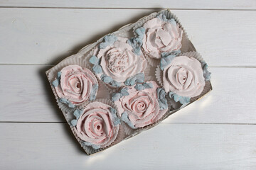 Homemade marshmallows in a cardboard box. Zephyr flowers. Gift wrap.