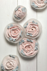 Homemade marshmallows. Zephyr flowers. On white boards.