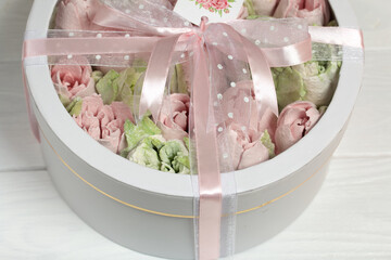 Homemade marshmallows in a cardboard box. Zephyr flowers. Box with transparent lid. Gift wrap. Tied with ribbon.