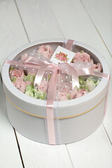 Homemade marshmallows in a cardboard box. Zephyr flowers. Box with transparent lid. Gift wrap. Tied...