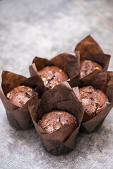 chocolate cupcakes in a paper wrapper on the table. home bakery concept.