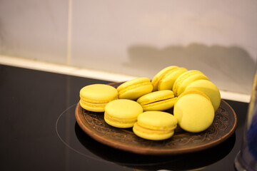 yellow halves for macaroons cookies on the table. home bakery concept.