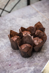 chocolate cupcakes in a paper wrapper on the table. home bakery concept.