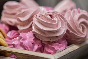 handmade fruit marshmallows and cookies in a wooden tray on the table. home bakery concept.