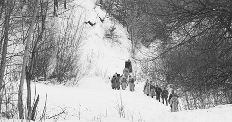 Men Dressed As White Guard Soldiers Of Imperial Russian Army In Russian Civil War s Marching Through Snowy Winter Forest. Historical Reenactment.
