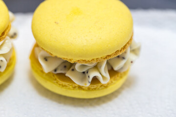 yellow beautiful macarons cookies on the table. home bakery concept.