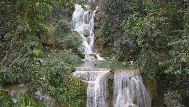 Natural beauty of Kuang Si Waterfall tiers in rural green Laos jungle
