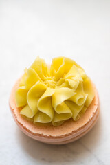 yellow beautiful macarons cookies on the table. home bakery concept.