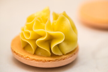 yellow beautiful macarons cookies on the table. home bakery concept.