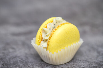 yellow beautiful macarons cookies on the table. home bakery concept.