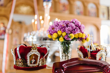 Wedding crowns. Wedding crowns decorated with gold and icons in church ready for marriage ceremony. close up. Divine Liturgy.