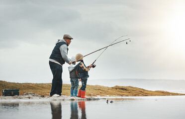 Lake, outdoor and grandfather fishing with children while on a adventure, holiday or weekend trip....