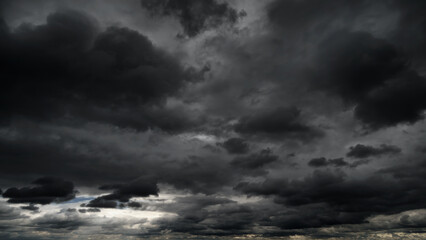 dark dramatic sky with black stormy clouds before rain or snow as abstract background, extreme...