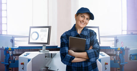 Engineer uses a digital tablet to control robots in a smart factory. Smart industry 4.0 concept