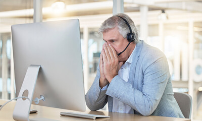 Call center, customer service and anxiety with a consultant man suffering from stress while working in the office. Crm, support or burnout with a senior male telemarketing working feeling overwhelmed