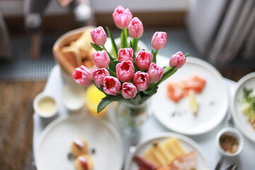 Festive breakfast in the room with flowers