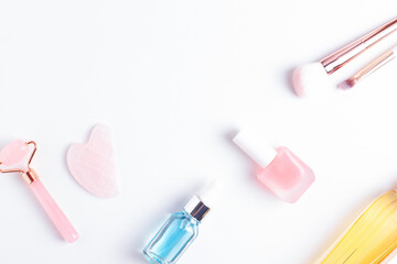 Beauty and self care flat lay with copy space. Face care, nail care and makeup accessories arranged on white background, top view.