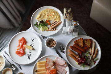Breakfast in bed, room service.  Omelet, salmon, sausages. Morning in the hotel room. Breakfast on the trip.