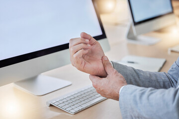 Hand, arthritis and joint pain with a business man in his office, sitting at a desk suffering from carpal tunnel. Stress, medical or anatomy and a male employee struggling with osteoporosis or injury